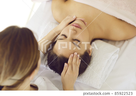 Top view close up of dermatologist make skincare procedures for healthy flawless face skin for client in beauty salon. Cosmetologist do lifting facial massage for woman in clinic. Cosmetology. 85922523