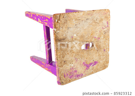 Old wooden stool with peeling pink paint. Loft style chair isolated on a white background. 85923312