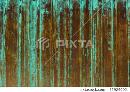 rusted corrugated steel sheet with leftovers of decayed and washed out green paint 85924003