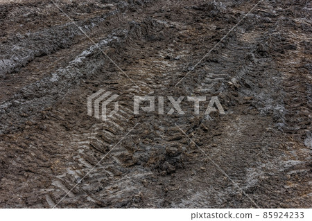 Wet dirt road after rain. Clay, dirt and soil at cloudy day light in autumn season. Wet dirt road after rain. Clay, dirt and soil at cloudy day light in autumn season. 85924233