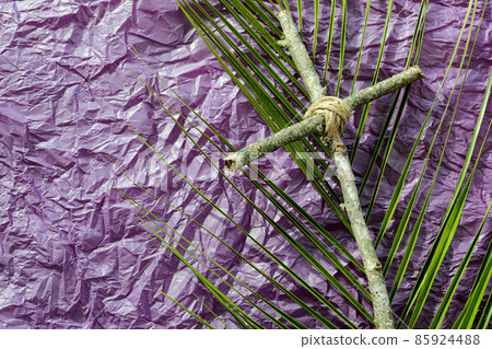 Good Friday, Lent Season and Holy Week concept. A Christian cross  and palm leaf on purple background. 85924488