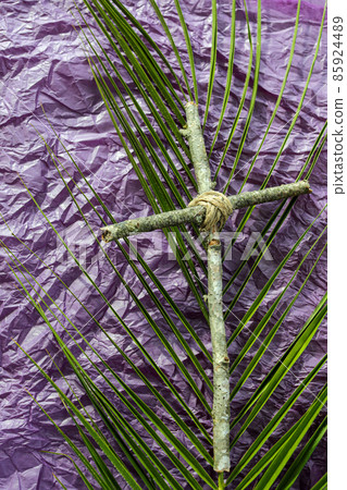 Good Friday, Lent Season and Holy Week concept. A Christian cross  and palm leaf on purple background. 85924489