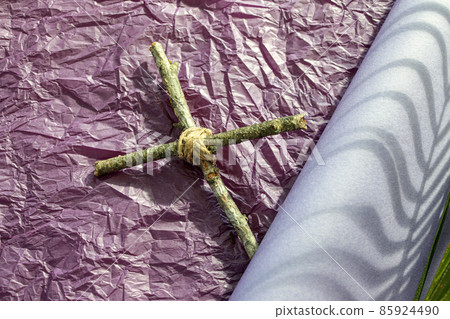 Good Friday, Lent Season and Holy Week concept. A Christian cross  and shadow of palm leaf on purple background.  85924490