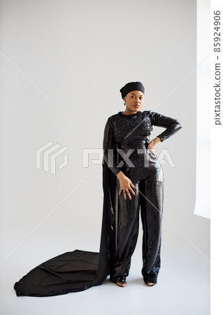 African woman in black evening wear posing indoors African woman in black evening wear posing indoors 85924906