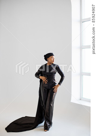 African woman in hijab and black evening wear posing indoors African woman in hijab and black evening wear posing indoors 85924907