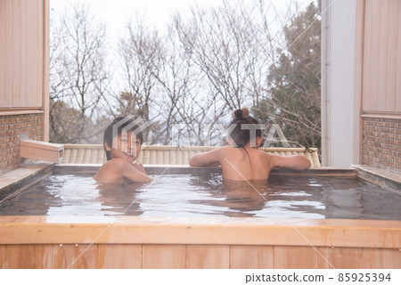 Child entering outdoor bath 85925394