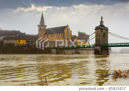 Seyssel embankment on Rhone river with Saint-Blaise church and suspension bridge in winter 85925837