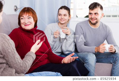 Family enjoying conversation with female Family enjoying conversation with female 85925934
