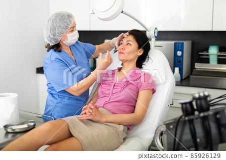 Cosmetologist giving beauty injections for face skin to female client Cosmetologist giving beauty injections for face skin to female client 85926129