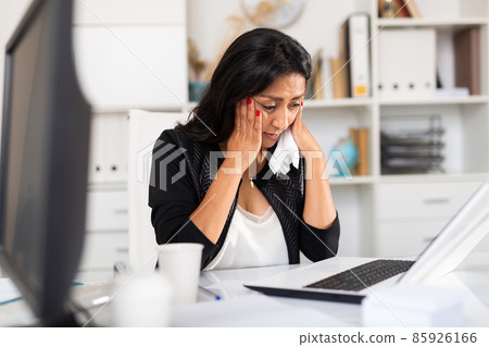 Upset business woman crying at workplace in office 85926166