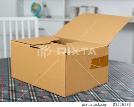 One cardboard box on top of table 85926188