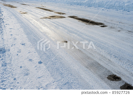 Frozen road surface in winter Frozen road surface in winter 85927726