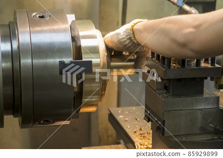 The machine operator working with brass material parts on lathe machine. The machine operator working with brass material parts on lathe machine. 85929899
