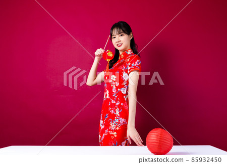 Pretty girl in red cheongsam on red background 85932450