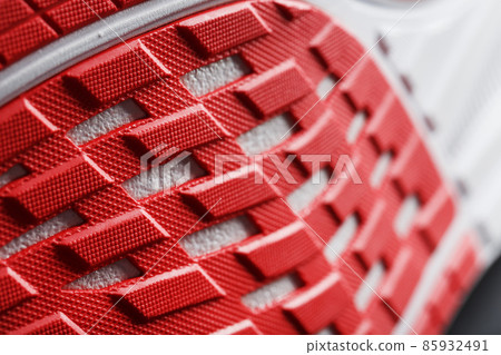 Close-up of the sole of a sport running shoe for running in red 85932491