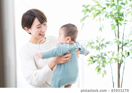 A mother holding a baby A mother holding a baby 85933278