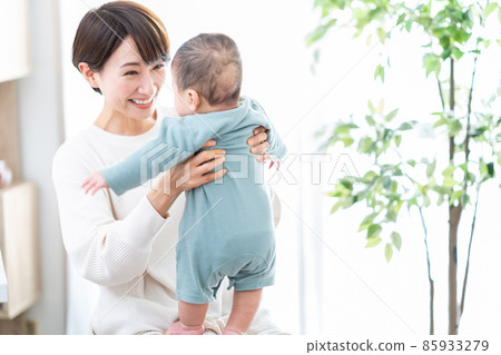 A mother holding a baby A mother holding a baby 85933279