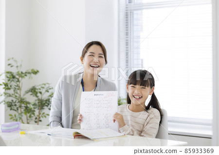Girl elementary school student who is pleased with the result of the test at the cram school Girl elementary school student who is pleased with the result of the test at the cram school 85933369
