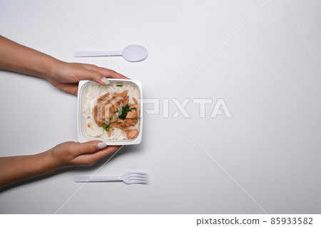 Young woman holding frozen fried pork with garlic in packaging on white background with copy space. 85933582
