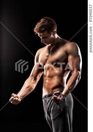 Image of very muscular man posing with naked torso 85940037