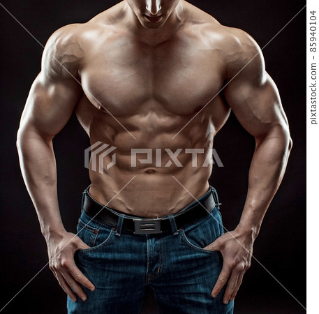 Muscular bodybuilder guy doing posing over black background 85940104