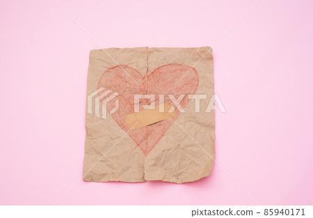 love concept - torn red heart on paper glued with plaster on a pink background. Broken love concept love concept - torn red heart on paper glued with plaster on a pink background. Broken love concept 85940171