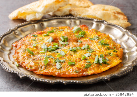 Close up view of spicy Indian masala omelette on plate. Horizontal Close up view of spicy Indian masala omelette on plate. Horizontal 85942984