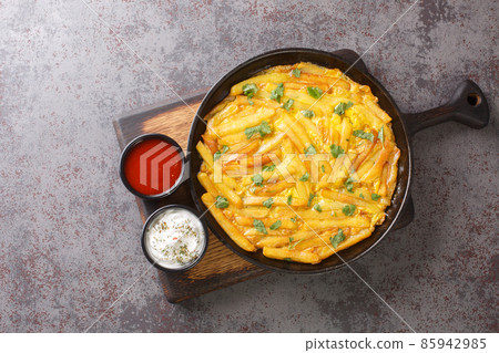 Chips mayai the Tanzanian street food dish is a humble omelet consisting of chips fries and mayai the Swahili word for eggs close up in the plate. Horizontal top view 85942985