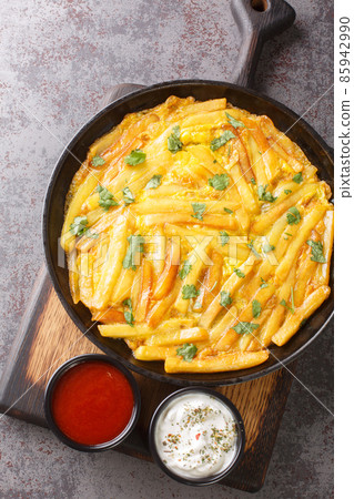 Tanzanian special dish Chips Mayai French Fries Omelette close up in the plate. Vertical top view Tanzanian special dish Chips Mayai French Fries Omelette close up in the plate. Vertical top view 85942990