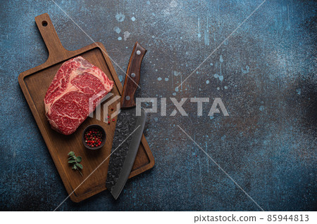 Raw meat beef marbled prime cut steak Ribeye on wooden cutting board Raw meat beef marbled prime cut steak Ribeye on wooden cutting board 85944813