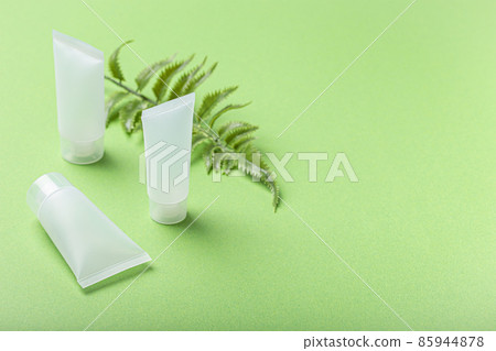 Skincare organic beauty product bottles, plant leaves on green background Skincare organic beauty product bottles, plant leaves on green background 85944878
