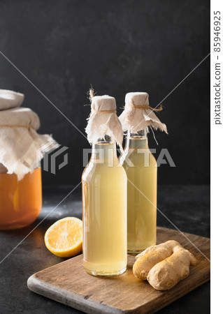 Homemade Kombucha healthy tasty drink in bottle and glass with lemon garnish mint. 85946925