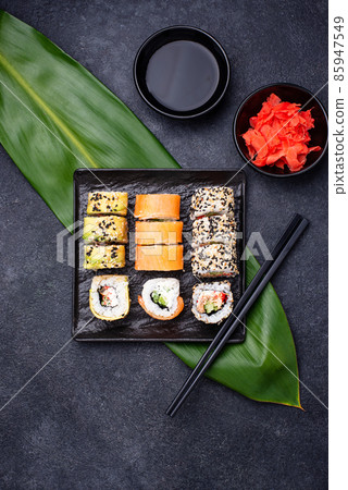 Traditional Japanese sushi rolls on dark background 85947549