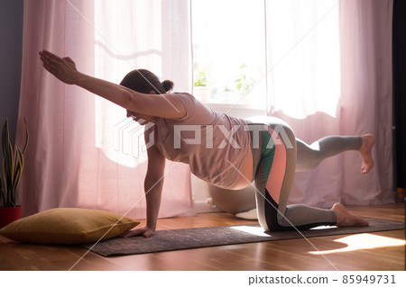 Pregnant woman on fitness mat, training at home 85949731