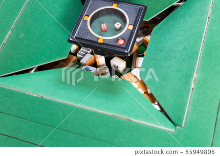 Mixing mahjong tiles at an electric mahjong table Mixing mahjong tiles at an electric mahjong table 85949808