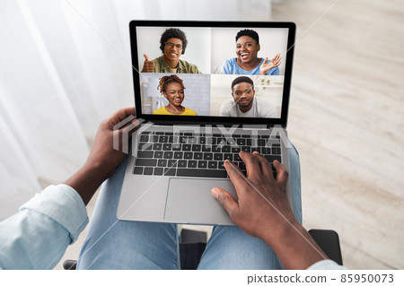 Black man in wheelchair using computer, having online party 85950073