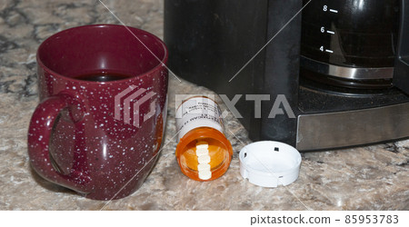 Coffee cup with prescription pill bottle and coffee machine 85953783
