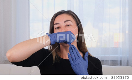 female doctor cosmetologist gives buccal facial massage to herself, teaching and showing Intra oral female doctor cosmetologist gives buccal facial massage to herself, teaching and showing Intra oral 85955570