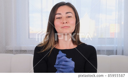 Woman in blue protective gloves using disinfectant hand wash gel to prevent virus epidemic or Woman in blue protective gloves using disinfectant hand wash gel to prevent virus epidemic or 85955587