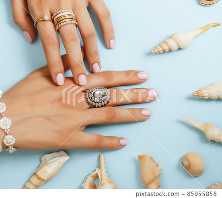 beautiful woman hands with pink manicure holding plate with pearls and sea shells, luxury jewelry concept beautiful woman hands with pink manicure holding plate with pearls and sea shells, luxury jewelry concept 85955858