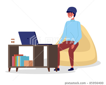 Man in medical mask sitting at a table in room correspondence surfing the Internet during quarantine 85956400