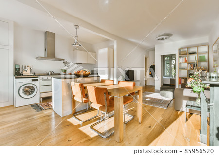 Delightful daylight dining room with wooden table 85956520
