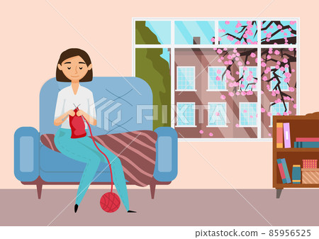 Young girl is engaged in knitting. Woman having fun making warm clothes while sitting on an armchair 85956525