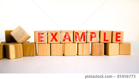 Example symbol. The concept word Example on wooden cubes. Beautiful white table, white background, copy space. Business and example concept. 85956773