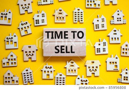 Time to sell house symbol. Concept words 'Time to sell' on wooden blocks near miniature houses. Beautiful yellow background, copy space. Business and time to sell house concept. Time to sell house symbol. Concept words 'Time to sell' on wooden blocks near miniature houses. Beautiful yellow background, copy space. Business and time to sell house concept. 85956808