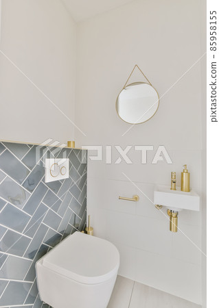 Stunning washroom with blue tiles and small round mirror Stunning washroom with blue tiles and small round mirror 85958155