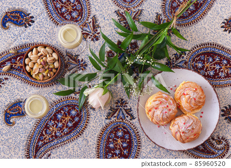 Celebrate romantic Valentine day with your love, bring flower with tasty desserts and toasting with pistachio eggnog. Flat lay, top down view. 85960520