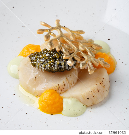 Baked scallop with black caviar. 85961083