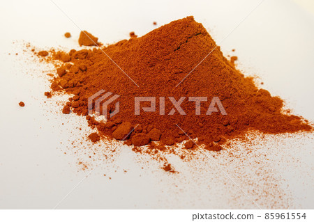 Pile of red paprika powder. Smoked paprika. Seasoning on a white background. Ground pepper. Pile of red paprika powder. Smoked paprika. Seasoning on a white background. Ground pepper. 85961554