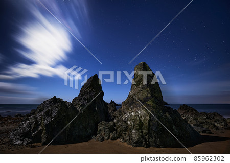 Kilfarrasy Strand night photography. Copper Coast of Waterford, Ireland. world geopark by unesco. impressive rocks at night with moon behind some clouds. Kilfarrasy Strand night photography. Copper Coast of Waterford, Ireland. world geopark by unesco. impressive rocks at night with moon behind some clouds. 85962302